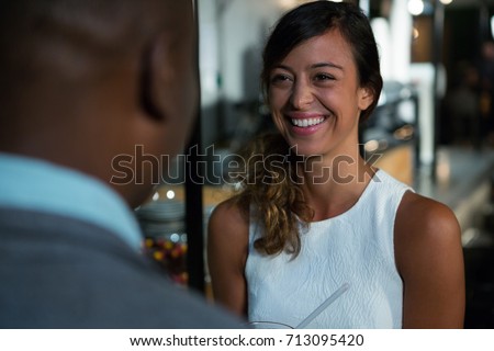 Beautiful woman interacting with man in restaurant