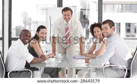Senior Business man giving a presentation to a group of people