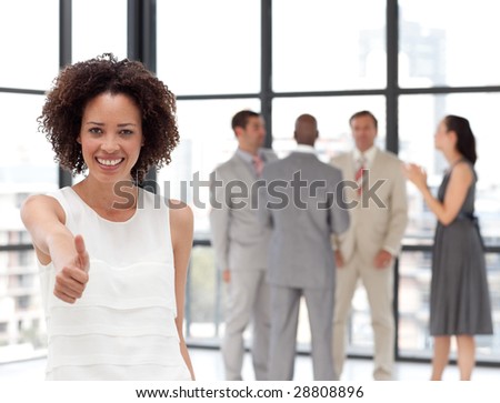 Smiling business woman showing team spirit on from of Business Team