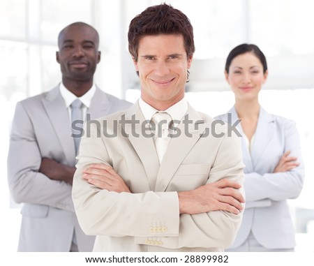 Young Business man smiling in front of Business team