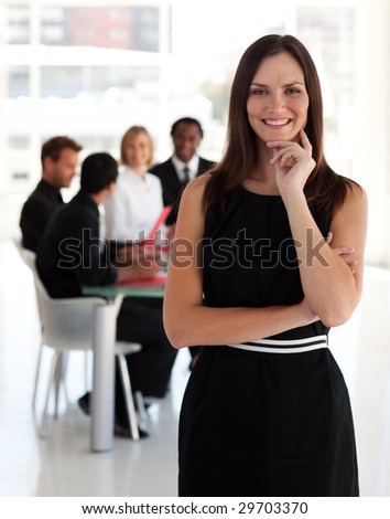 Young Female leader in standing in front of team