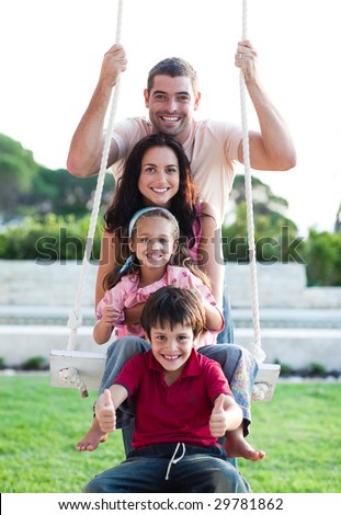Family having fun on a swing