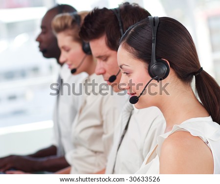 Mixed race business called centre with people on headsets