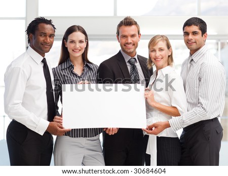 Business team holding a blank card in front of the camera