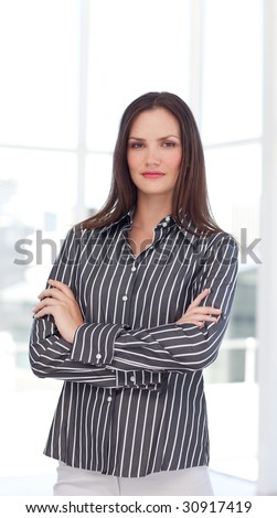 Attractive young businesswoman with folded arms