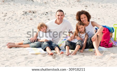 Happy family sitting on a beach