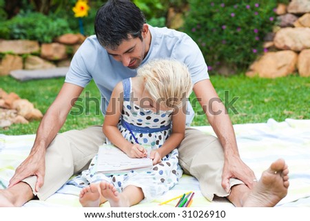 Father and daughter writing in garden