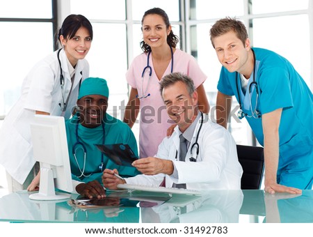 Group of doctors in a meeting looking at the camera