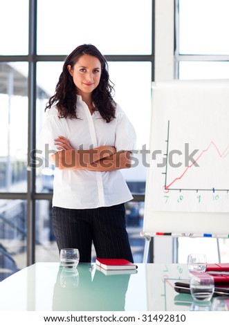 Confident businesswoman with folded arms in a presentation