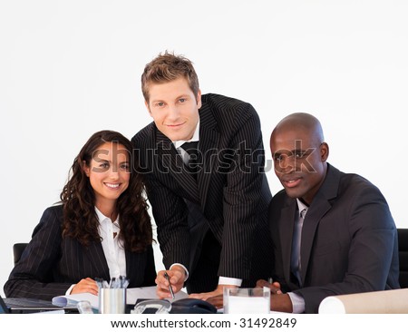 Multi-ethnic business team in a meeting looking at the camera