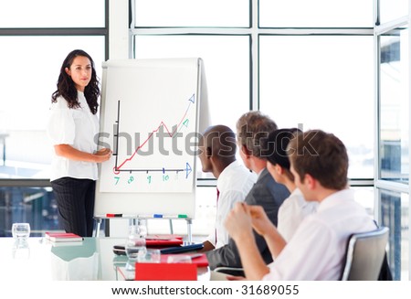 Young businessswoman reporting to sales figures in a meeting