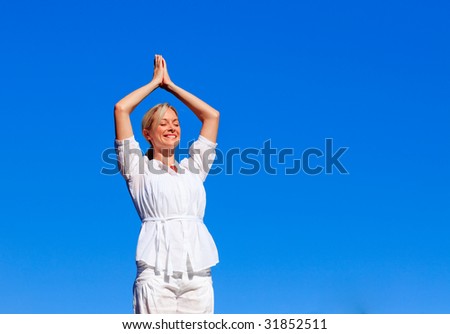 Young girl practicing yoga outdoors with copy-space