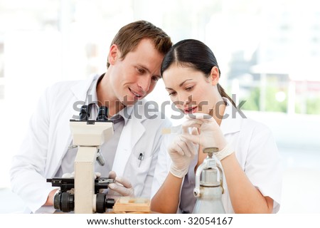 Students of science examining a slide in a laboratory