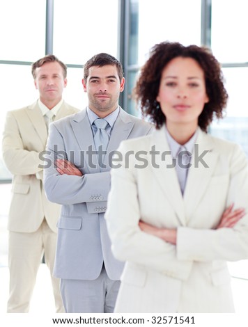 Serious and confident businessman with folded arms in a line