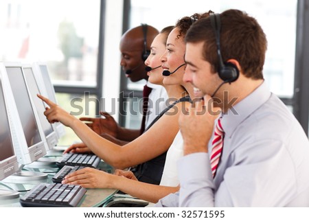 Attractive young businessman working in a call center