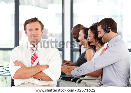 Senior leadership with crossed arms working in a call center