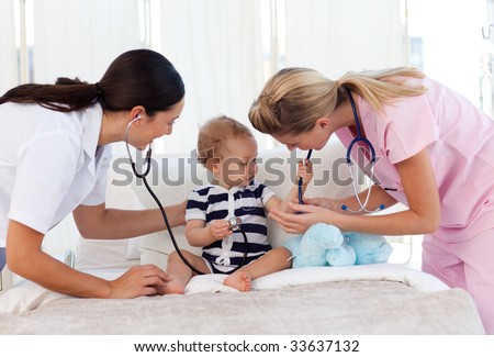 Baby playing with stethoscopes in hospital