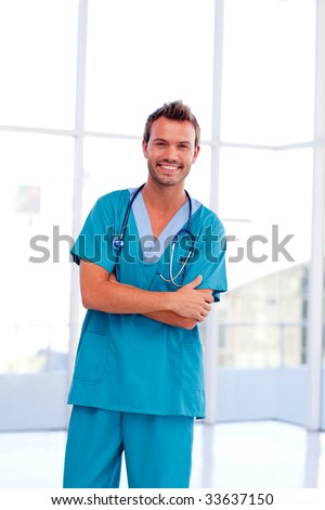 Smiling handsome doctor isolated in hospital in front of the camera