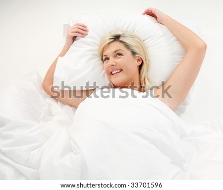 Happy beautiful girl lying in bed