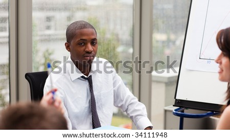 Afro-American businessman interacting with his colleagues in a meeting