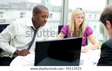 Multi-ethnic business team interacting with each other in office