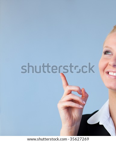Young Happy Businesswoman pointing upwards