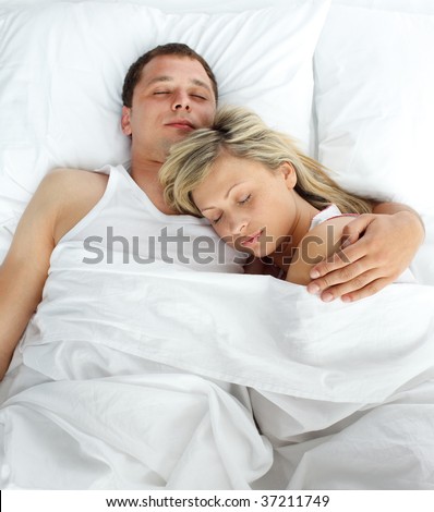 stock photo : High view of couple sleeping in bed together