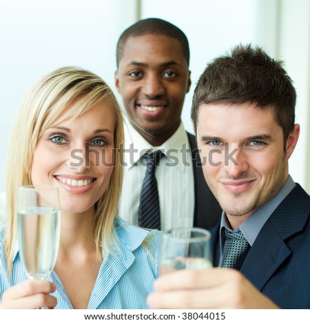 Portrait of business people toasting with champagne in an office