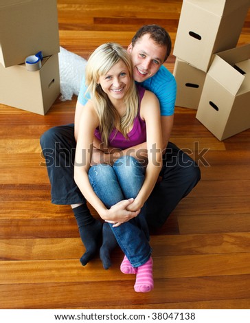 High angle of a couple sitting on floor together. Moving house