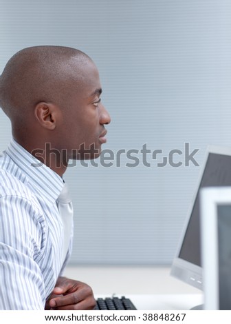 Afro-American businessman working in office with a computer
