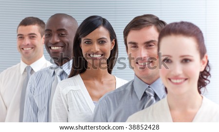 Business team in a line smiling at the camera. Focus on a Indian woman