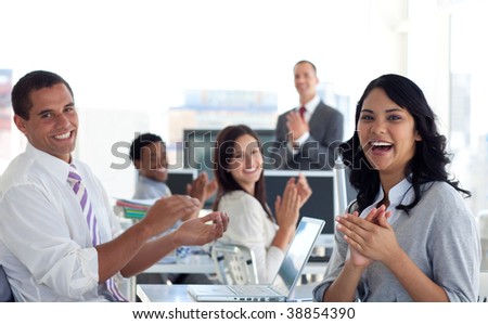 Business team applauding successful project in office
