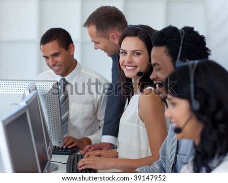 Multi-ethnic business team working in a call center with a manager