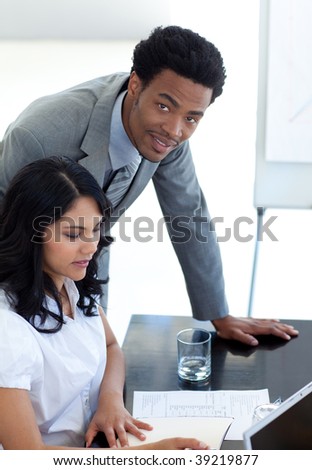 Afro-American businessman helping his colleague in office