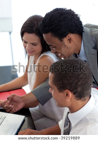 Afro-American businessman working with his colleagues in office