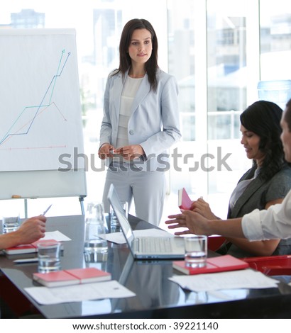 Attractive businesswoman talking to her colleague in a presentation