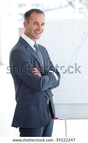Mature businessman reporting to sales figures to his team