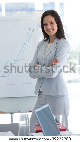 Confident smiling businesswoman giving a presentation