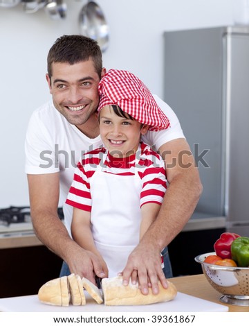 Father and son cutting bread in kitchen