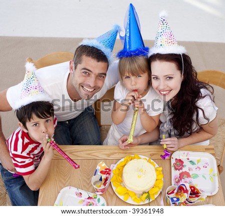 High angle of little girl celebrating her birthday with her family