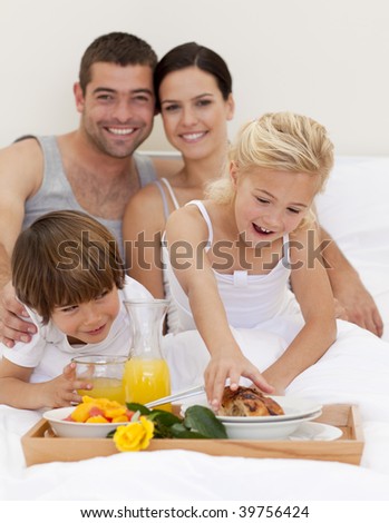 Family eating nutritive breakfast in bedroom