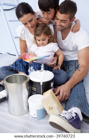 Happy family chosing color to paint a bedroom