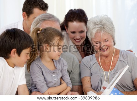 Family giving a present to the grandmother at home
