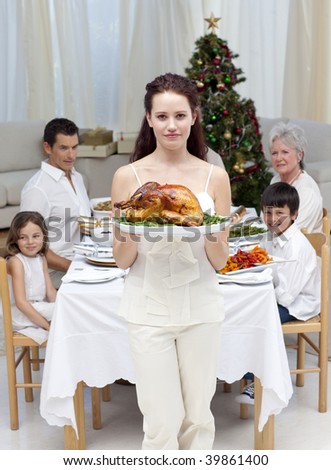 Mother showing turkey for Christmas dinner at home