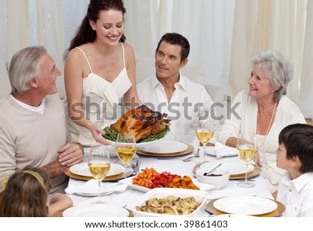 Woman showing turkey to her family for Christmas dinner at home