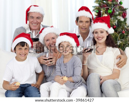 Family celebrating Christmas with wine and sweets at home
