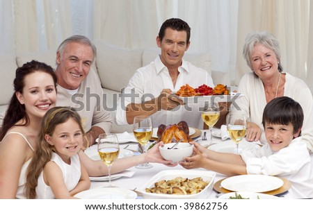 Grandparents, parents and children having a family dinner at home