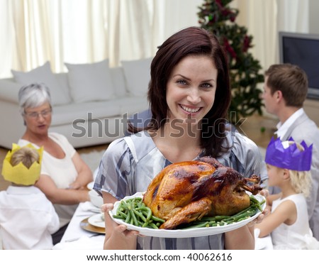 stock photo Woman showing Christmas turkey for family dinner at home