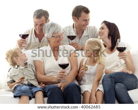 Happy family having a celebration with wine and eating biscuits