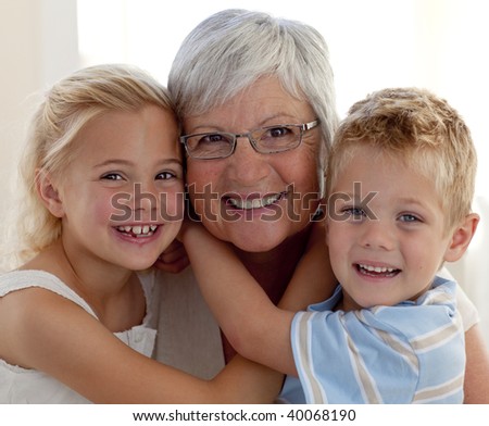 Portrait of smiling grandmother and grandchildren hugging